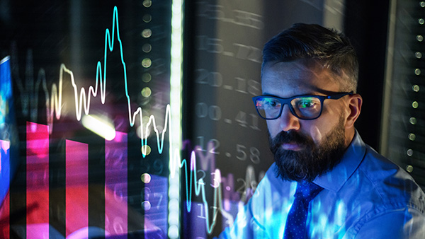 Image: Business man sees markets crashing on his monitor.